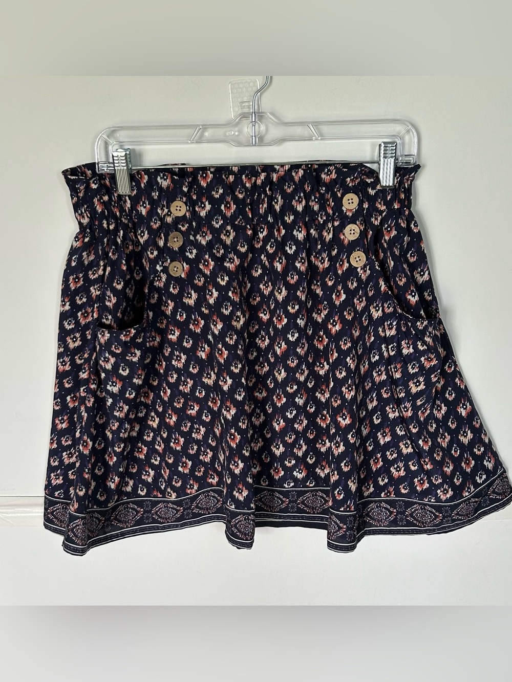 Maurices woman’s Navy Floral Button-Accent Mini Skirt, pockets on front. Size M